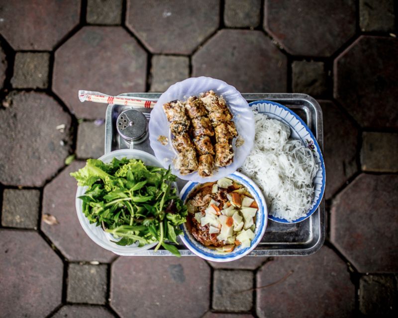 Hanoi: 7 Tastings Street Food Tour with Train Street - Entering Hanoi’s Old Quarter at Food-Guide Speed