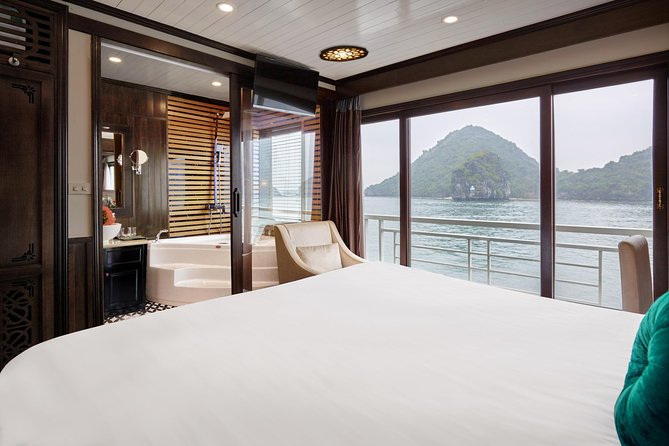 Overnight Luxury 5 Star Alisa Cruise with Meals, Kayak or Bamboo Boat - Day 1 through Ha Long Bay: caves, floating village pass-bys, and a sunset bar